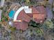 Expansive home with a red tile roof, curved driveway, and an inviting backyard pool and spa at 42171 N Saguaro Forest Dr, Scottsdale, AZ 85262