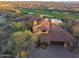 An aerial shot of a property showcasing beautiful desert landscaping and a well maintained brick driveway at 42171 N Saguaro Forest Dr, Scottsdale, AZ 85262