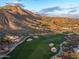 Expansive aerial view of a desert property on a golf course with stunning mountain views in the background at 42171 N Saguaro Forest Dr, Scottsdale, AZ 85262