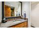 A bathroom vanity with a large mirror, mosaic details, and wooden cabinetry at 42171 N Saguaro Forest Dr, Scottsdale, AZ 85262