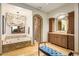 Luxurious bathroom with chandelier, bathtub, walk-in shower, and dark wood cabinetry at 42171 N Saguaro Forest Dr, Scottsdale, AZ 85262