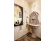 Charming powder room featuring unique stone sink, textured walls and decorative mirror at 42171 N Saguaro Forest Dr, Scottsdale, AZ 85262