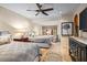 Bright bedroom with a window, TV, two beds and wooden floors and an area rug at 42171 N Saguaro Forest Dr, Scottsdale, AZ 85262