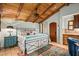 Bedroom boasting a wood-beamed ceiling, custom cabinets, and charming Southwestern decor at 42171 N Saguaro Forest Dr, Scottsdale, AZ 85262