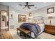 Elegant bedroom features a ceiling fan, an area rug, and an ensuite bathroom at 42171 N Saguaro Forest Dr, Scottsdale, AZ 85262