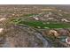 Scenic aerial view of a lush desert golf community with beautiful homes and verdant green fairways at 42171 N Saguaro Forest Dr, Scottsdale, AZ 85262