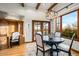 Cozy dining area with custom desk, natural light, wood floors, and backyard view at 42171 N Saguaro Forest Dr, Scottsdale, AZ 85262