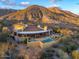 An inviting home featuring a pool, stone accents, and a covered patio ideal for outdoor relaxation and entertaining at 42171 N Saguaro Forest Dr, Scottsdale, AZ 85262