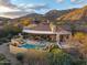 An inviting home featuring a pool, stone accents, and a covered patio ideal for outdoor relaxation and entertaining at 42171 N Saguaro Forest Dr, Scottsdale, AZ 85262