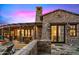 Gorgeous desert home featuring a stone facade, covered patio, and well-manicured landscaping, blending seamlessly with the natural surroundings at 42171 N Saguaro Forest Dr, Scottsdale, AZ 85262