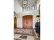 Spacious foyer showcases a tall ceiling, stone floors, a double door, and a decorative chandelier at 42171 N Saguaro Forest Dr, Scottsdale, AZ 85262