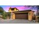 A grand, wooden garage door complements the desert landscape and hints at the home's desert setting at 42171 N Saguaro Forest Dr, Scottsdale, AZ 85262