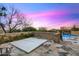 Relaxing hot tub area features a stone privacy wall, beautiful desert landscape and a pool, perfect for unwinding at 42171 N Saguaro Forest Dr, Scottsdale, AZ 85262