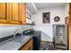 A convenient laundry room features a modern washer and dryer, a wine cooler, and custom cabinets at 42171 N Saguaro Forest Dr, Scottsdale, AZ 85262