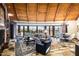 Inviting living room with wood beam ceilings, floor-to-ceiling windows, and stylish furniture at 42171 N Saguaro Forest Dr, Scottsdale, AZ 85262