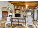 Elegant living room features a stone accent wall, wood beam ceilings, and natural light at 42171 N Saguaro Forest Dr, Scottsdale, AZ 85262