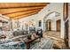 Open-concept living room with beamed ceiling, stone floors, and seamless access to the kitchen at 42171 N Saguaro Forest Dr, Scottsdale, AZ 85262