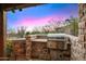 Outdoor built in grill area features desert landscape views and is perfect for outdoor entertaining at 42171 N Saguaro Forest Dr, Scottsdale, AZ 85262