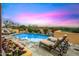 Relaxing poolside scene with lounge chairs and colorful flowerbeds, offering a perfect spot to unwind and enjoy the serene desert landscape at 42171 N Saguaro Forest Dr, Scottsdale, AZ 85262