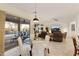 Open dining area with glass table and chairs, leading to an outdoor patio with a pool at 4320 E Ficus Way, Gilbert, AZ 85298