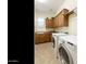 The laundry room has tile floors and is equipped with washer, dryer, sink and cabinets at 4320 E Ficus Way, Gilbert, AZ 85298