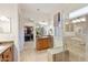 Beautiful main bathroom with glass shower, dual sinks, and walk-in closet at 4320 E Ficus Way, Gilbert, AZ 85298