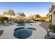 Inviting pool and spa with stone accents, landscaping, and comfortable lounging spaces at 4320 E Ficus Way, Gilbert, AZ 85298