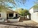 The charming backyard features a covered patio with beautiful landscaping, a grill, and privacy wall at 4643 E Cherry Hills Dr, Chandler, AZ 85249