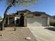 Tan stucco single-story home features a tile roof, arched entry, and a two-car garage, complemented by desert landscaping at 4643 E Cherry Hills Dr, Chandler, AZ 85249