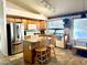 Functional kitchen with tiled floors, wood cabinets, stainless steel refrigerator, and center island at 4643 E Cherry Hills Dr, Chandler, AZ 85249