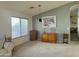 Living room featuring a large window, a gray accent wall, a modern pendant light, and neutral carpet at 4643 E Cherry Hills Dr, Chandler, AZ 85249