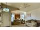 Bright living room featuring a vaulted ceiling, ceiling fan, large windows, and neutral colored couches at 4643 E Cherry Hills Dr, Chandler, AZ 85249