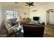 Spacious living room with a ceiling fan, large windows, tiled flooring, and comfortable sofas at 4643 E Cherry Hills Dr, Chandler, AZ 85249