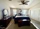 Primary bedroom featuring neutral colors, large windows with blinds, ceiling fan, and carpet at 4643 E Cherry Hills Dr, Chandler, AZ 85249