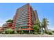 Street view of a modern high-rise building with unique architectural details and lush landscaping at 4808 N 24Th St # 1427, Phoenix, AZ 85016