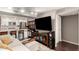 Modern living space blending the kitchen with a relaxing living area, featuring a large TV at 4808 N 24Th St # 1427, Phoenix, AZ 85016