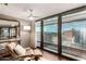 Bright living room with a chair and floor-to-ceiling windows showcasing expansive cityscape views at 4808 N 24Th St # 1427, Phoenix, AZ 85016