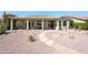 Charming home featuring a covered patio and a beautifully landscaped backyard with a stone pathway at 511 W Cherrywood Dr, Sun Lakes, AZ 85248