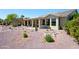 Home exterior featuring a covered patio and low-maintenance desert landscaping with mature cacti at 511 W Cherrywood Dr, Sun Lakes, AZ 85248