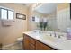 Bright and spacious bathroom with double vanity and a large mirror and a glass enclosed shower at 511 W Cherrywood Dr, Sun Lakes, AZ 85248