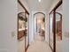 Hallway featuring mirrored closet doors which lead into a bathroom with a double vanity at 511 W Cherrywood Dr, Sun Lakes, AZ 85248