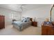 Bright bedroom featuring plantation shutters, plush carpet, and a neutral color palette at 511 W Cherrywood Dr, Sun Lakes, AZ 85248