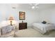 Cozy bedroom with neutral carpeting and a ceiling fan, perfect for relaxation at 511 W Cherrywood Dr, Sun Lakes, AZ 85248