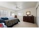 Well-lit bedroom featuring plantation shutters and neutral carpeting at 511 W Cherrywood Dr, Sun Lakes, AZ 85248