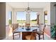 Elegant dining area showcasing a stylish chandelier and panoramic views of the verdant golf course at 511 W Cherrywood Dr, Sun Lakes, AZ 85248