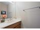 The powder room contains a marble countertop vanity and decorative wall mirror at 511 W Cherrywood Dr, Sun Lakes, AZ 85248