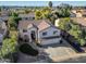 Aerial view of a spacious home with well-maintained landscaping, three-car garage, and a large driveway at 5291 W Angela Dr, Glendale, AZ 85308