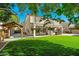 Backyard view showcasing lush artificial turf, a custom outdoor kitchen, and a pergola at 5291 W Angela Dr, Glendale, AZ 85308