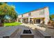 Expansive backyard with a fire pit, built-in bar, covered patio, and lush lawn for outdoor enjoyment at 5291 W Angela Dr, Glendale, AZ 85308