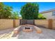 Backyard oasis featuring a tile patio, a fire pit area with seating, and a tranquil water feature at 5291 W Angela Dr, Glendale, AZ 85308